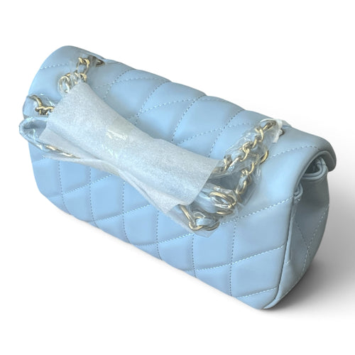 Superlative Online powder blue quilted shoulder handbag with gold-tone chain strap and protective packaging