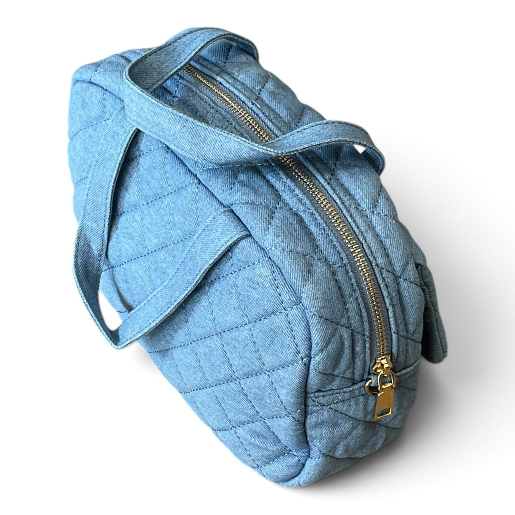 Superlative Online light blue quilted denim handbag with gold-tone zipper and top handles on a white background