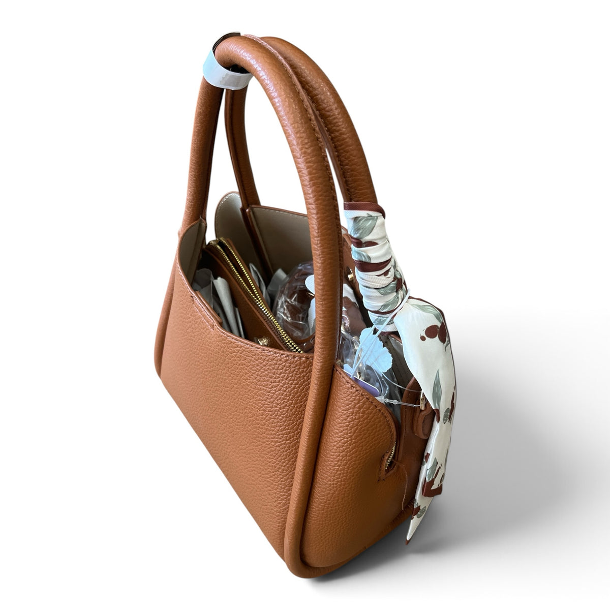 Superlative Online tan pebble-grain faux leather handbag with a floral scarf tied to the handle, side view.